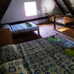 a room with two beds and a table and a window at Suri in Plužine