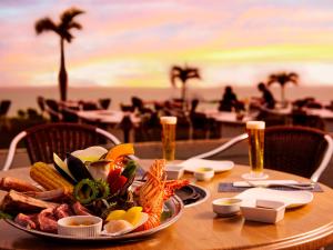 a table with a plate of food on the beach at Miyakojima Tokyu Hotel & Resorts in Miyako-jima