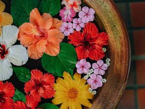 a bowl filled with colorful flowers on a table at Miyakojima Tokyu Hotel & Resorts in Miyako-jima