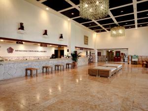 a lobby with a waiting area and a chandelier at Miyakojima Tokyu Hotel & Resorts in Miyako-jima