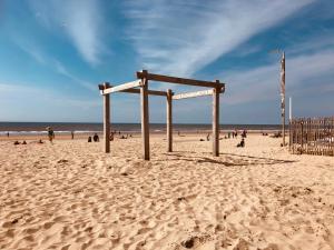 a wooden frame in the sand on a beach at LODGE 5 Zandvoort in Zandvoort