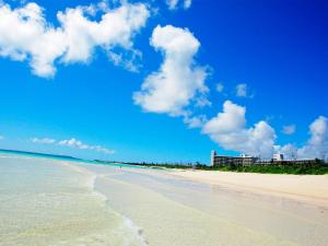 a view of a beach with the ocean and buildings at Miyakojima Tokyu Hotel & Resorts in Miyako Island