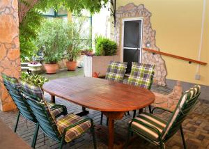a wooden table and chairs on a patio at Ferienwohnung Koppi in Pamhagen