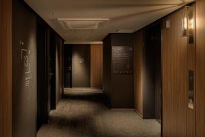 a hallway of a building with black walls at Bespoke Hotel Sapporo in Sapporo