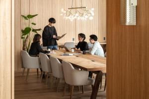 
people are sitting at a table in a restaurant at Bespoke Hotel Sapporo in Sapporo
