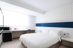 Postel nebo postele na pokoji v ubytování Dandy Hotel - Tianmu Branch
