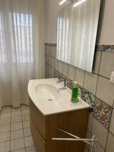 a bathroom with a sink and a mirror at Casa vacanze Rosanna in Porto SantʼElpidio