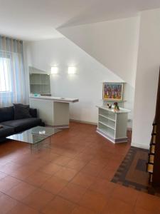 a living room with a couch and a table at Casa vacanze Rosanna in Porto SantʼElpidio