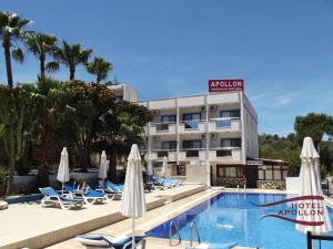 a hotel with a swimming pool with chairs and umbrellas at Apollon Hotel in Patara