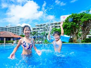 two children playing in the water at a swimming pool at Miyakojima Tokyu Hotel & Resorts in Miyako-jima