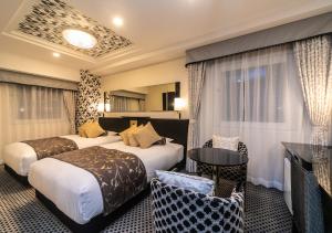 Postel nebo postele na pokoji v ubytování APA Hotel Namba Shinsaibashi Nishi