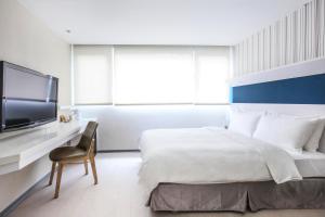 Postel nebo postele na pokoji v ubytování Dandy Hotel - Tianmu Branch