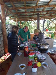 a group of people preparing food on a table at Bel-Zhan Yurt Lodge in Grigor'yevka