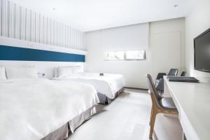 Postel nebo postele na pokoji v ubytování Dandy Hotel - Tianmu Branch