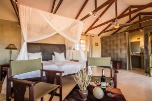 A bed or beds in a room at Bagatelle Kalahari Game Ranch