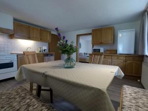 a kitchen with a table with a vase of flowers on it at Apartments Wolf in Reutte