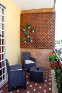 a patio with two chairs and a table and plants at Il Giusto bedandbreakfast in Lecce