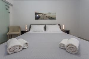 a bedroom with a bed with towels on it at Hvar luxury rooms in Hvar