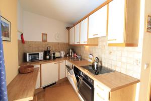 a kitchen with a sink and a stove top oven at CHALET SCHWALBENNEST in Bad Kleinkirchheim