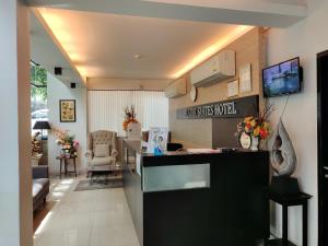 a room with a counter and a living room at Avatar Suites Hotel - SHA Extra Plus in Bangkok