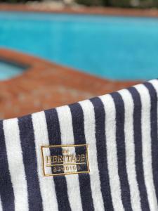 a close up of a striped towel with a logo on it at The Heritage Bendigo in Bendigo