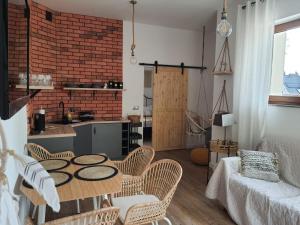 a kitchen and a living room with a table and chairs at Willa Sowia Dolina - parking i szybkie WiFi w cenie! in Karpacz