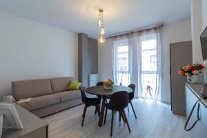 a living room with a table and a couch at Le Casette Di Osvaldo in Lecco