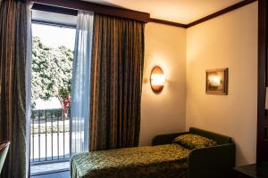 Posteľ alebo postele v izbe v ubytovaní Hotel Garibaldi