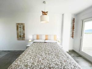 a large white bedroom with a large bed in it at Tarifa Beach Rentals Sunset in Tarifa