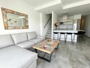 a living room with a couch and a table at Tarifa Beach Rentals Sunset in Tarifa