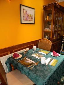 a dining room table with a blue table cloth at Sunnyside House in Rothesay +23 photos