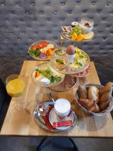 a table topped with plates of food and drinks at Urban Boutique Hotel in Vienna