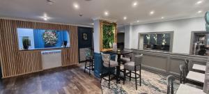 a bar with a table and chairs in a room at Birch Hotel in Heywood