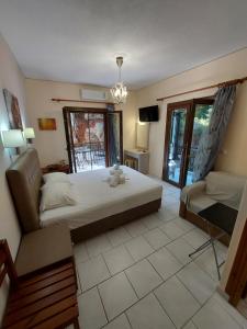 a bedroom with a bed and a couch and a tv at Mavra Studios in Lygia