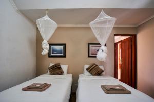 Voodi või voodid majutusasutuse Catembe Gallery Hotel toas