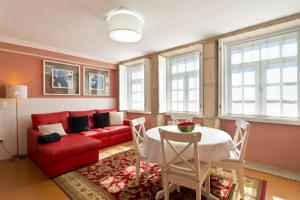a living room with a red couch and a table at Oporto Center Clean & Cozy Apt 3 in Porto