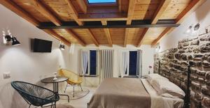 a bedroom with a bed and a stone wall at Arbanella in Corniglia