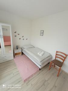 a bedroom with a bed and a chair and a table at Apartment LIKA in Gospić