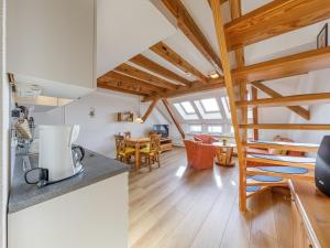 a kitchen and living room with a staircase in a house at Ferienwohnung Kietzspeicher in Waren