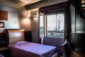 Posteľ alebo postele v izbe v ubytovaní Hotel Garibaldi