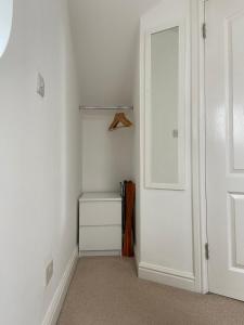 a room with a closet with a white door at Orchard cottage in Pucklechurch