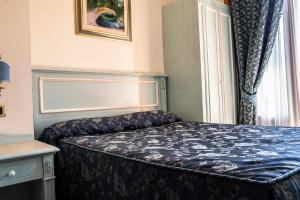 Posteľ alebo postele v izbe v ubytovaní Hotel Garibaldi