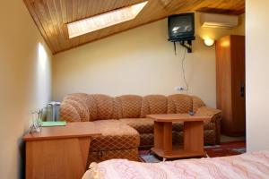 a living room with a couch and a table at Hotel Aquapark Alligator in Ternopil