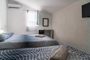 a bedroom with a bed with a black and white comforter at Hotel Praga in Gorno Lakočerej