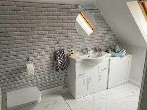 a bathroom with a sink and a mirror at Eagle's Nest Bullpits Golf Course in Bourton