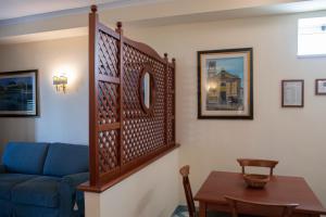 a living room with a blue couch and a table at Hotel Garibaldi in Milazzo