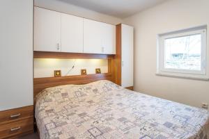 a bedroom with a bed and a window at Holiday Home Michael in Pinezici +14 photos