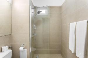 a bathroom with a shower with a glass door at Elizeu Hotel in Bucharest