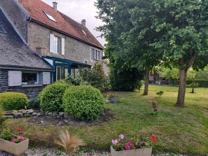 a garden in front of a house with flowers at Les fleurs du Mont in Céaux
