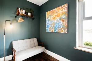 a room with a chair and a painting on the wall at The Old Vicarage in Cardigan